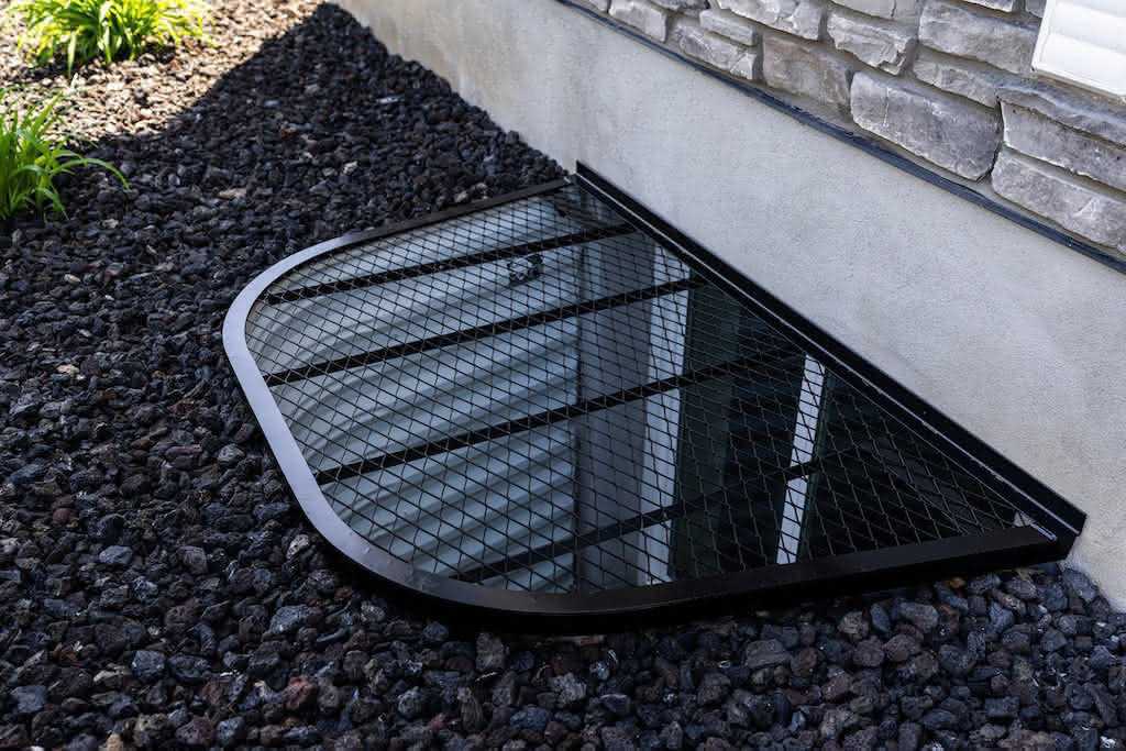 Steel window well cover with house