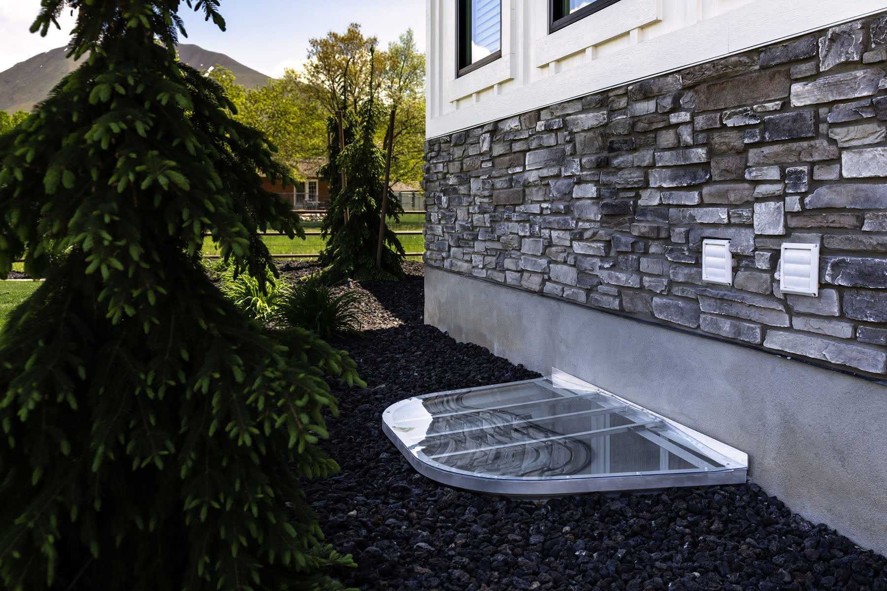 Steel window well cover with house